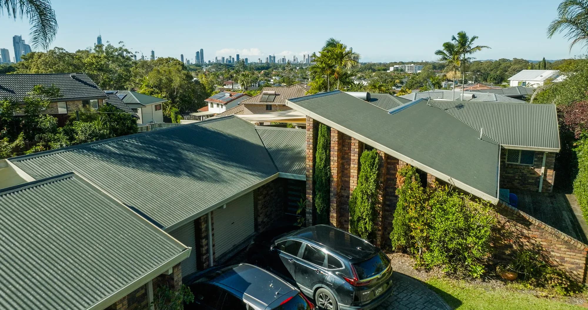 Aerial view of the new COLORBOND Custom Orb roof on the multi-level Benowa home