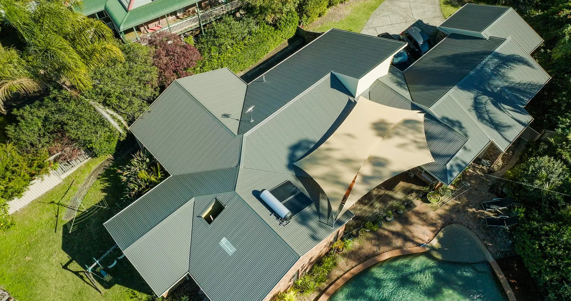 Aerial view of the new COLORBOND Custom Orb roof on the multi-level Benowa home