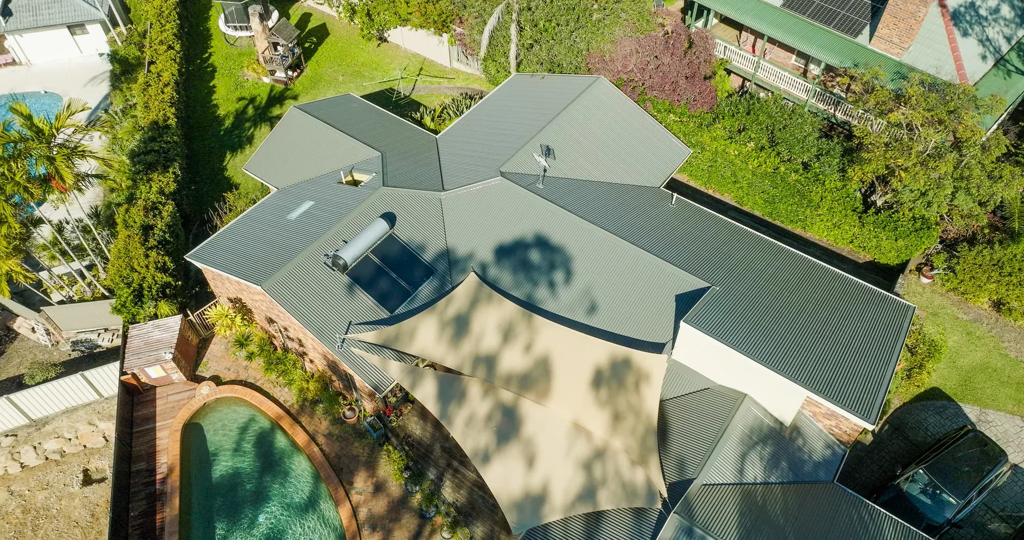Aerial view of the new COLORBOND Custom Orb roof on the multi-level Benowa home