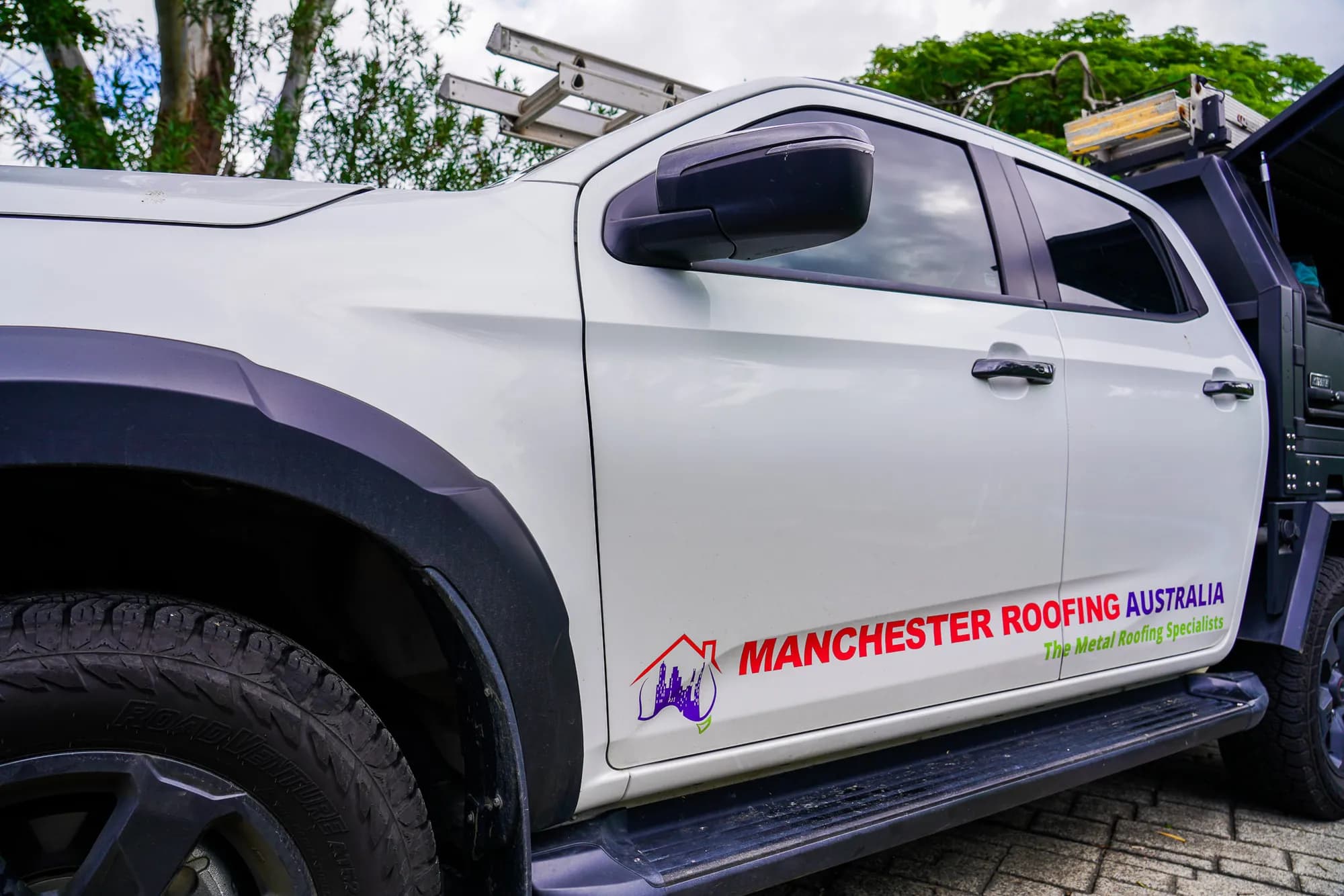 Manchester Roofing Australia work ute on site at Benowa