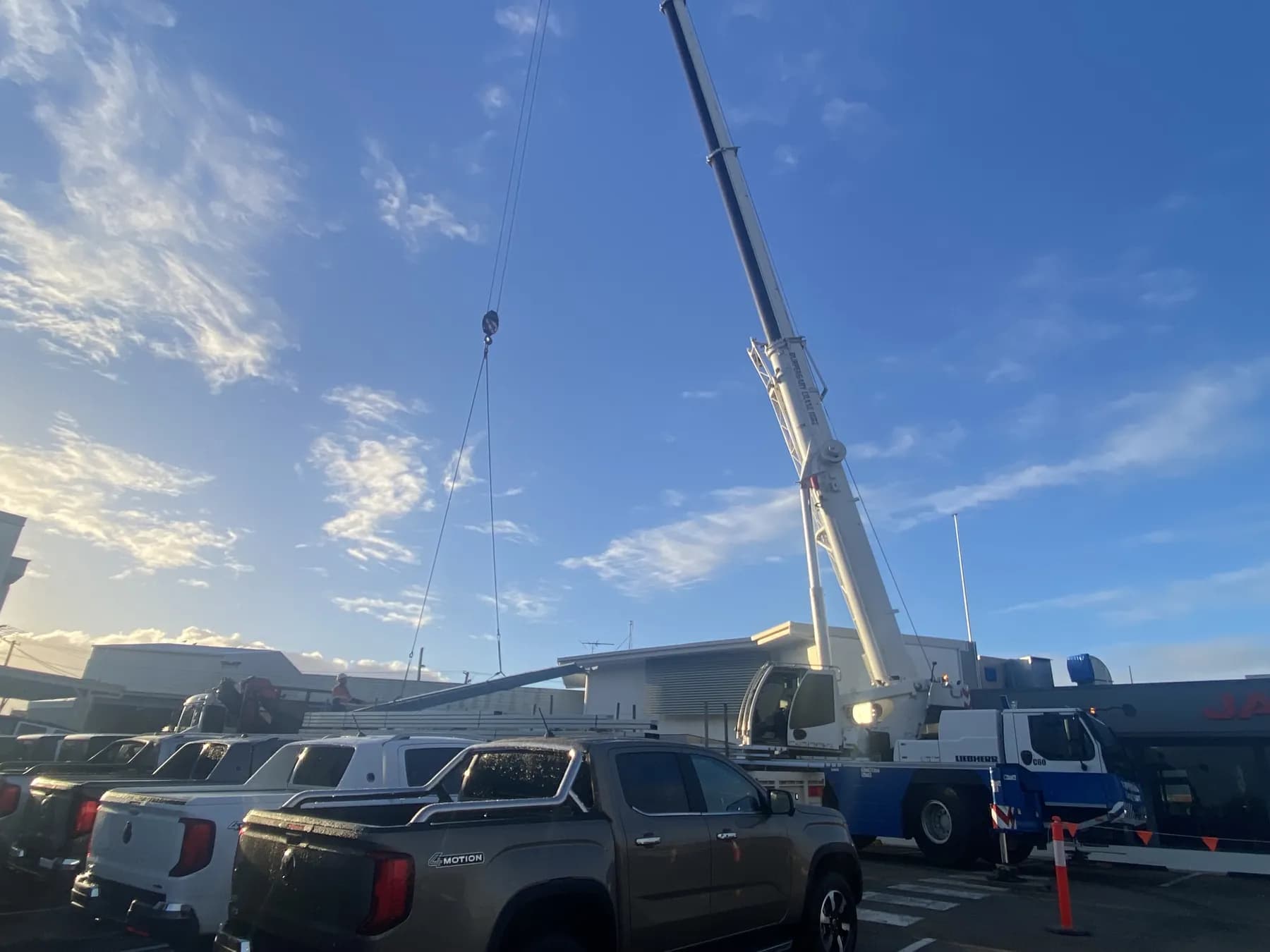 60T crane lifting roofing materials onto the Kippa-Ring car showroom roof