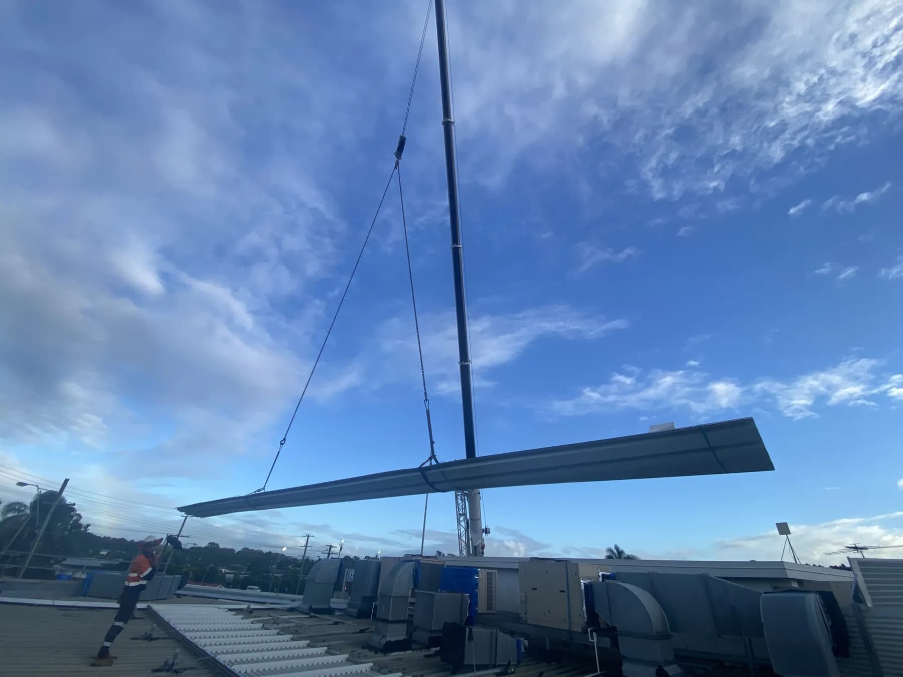 60T crane lifting roofing materials onto the Kippa-Ring car showroom roof
