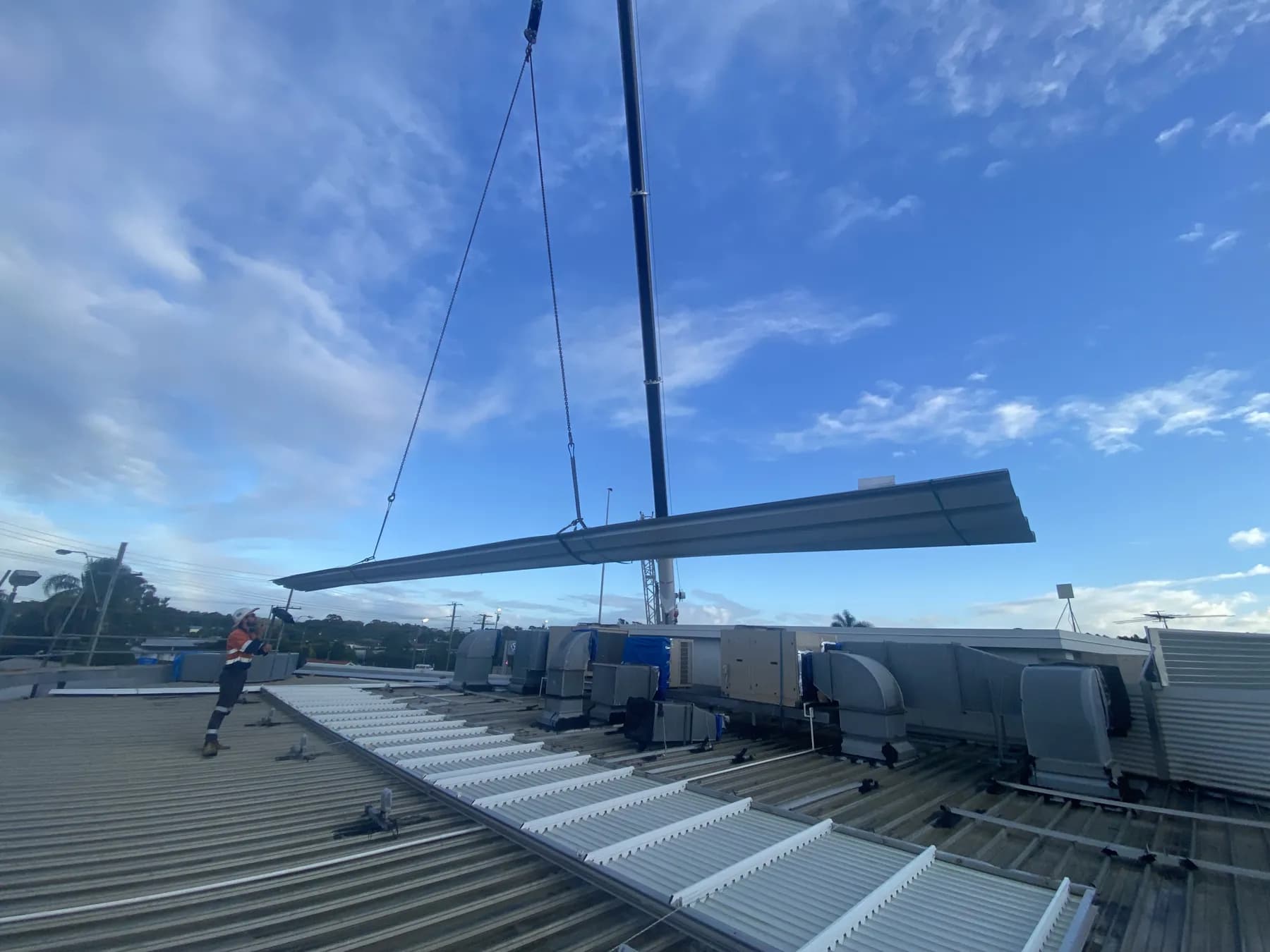 60T crane lifting roofing materials onto the Kippa-Ring car showroom roof