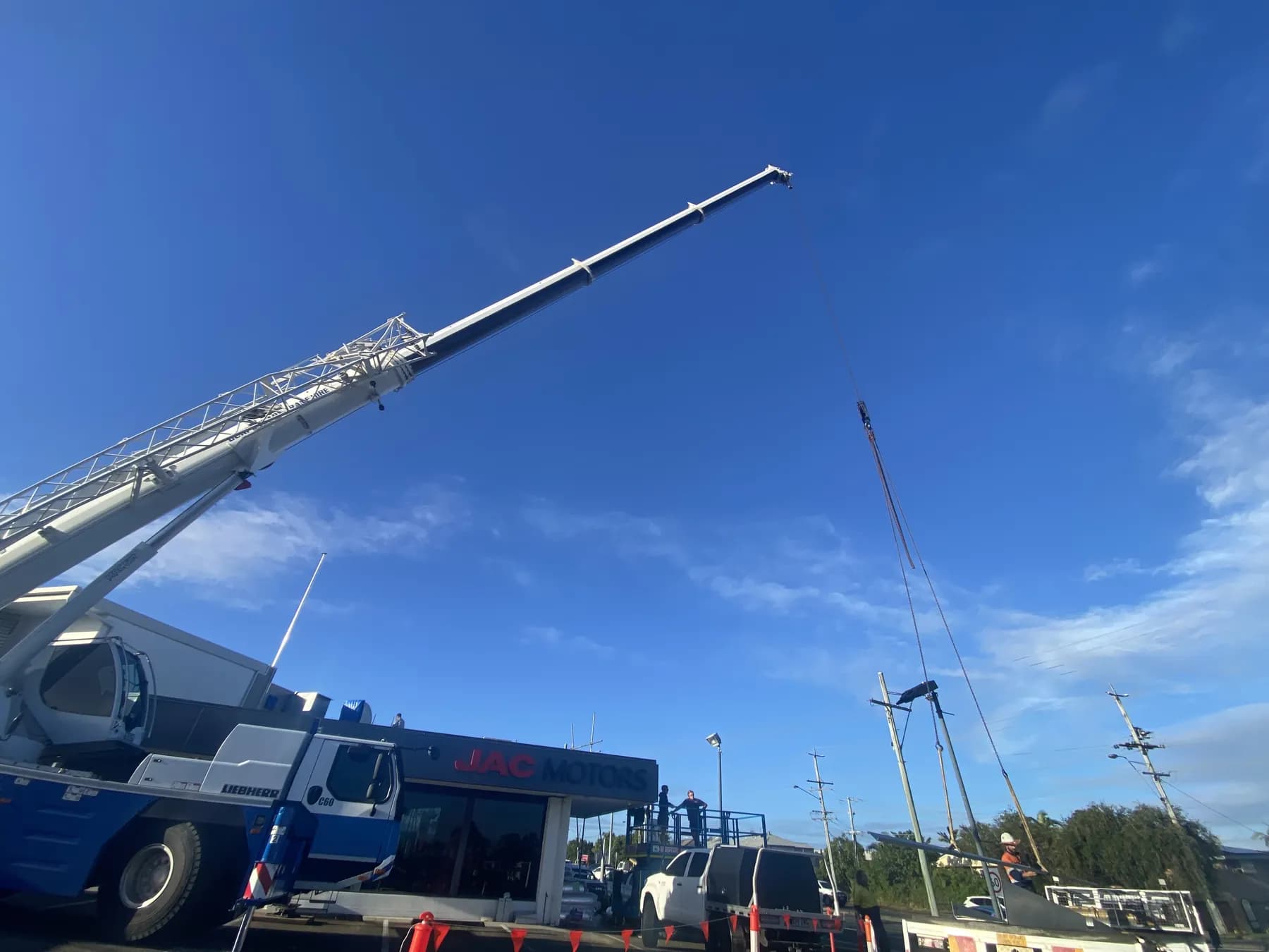 60T crane lifting roofing materials onto the Kippa-Ring car showroom roof