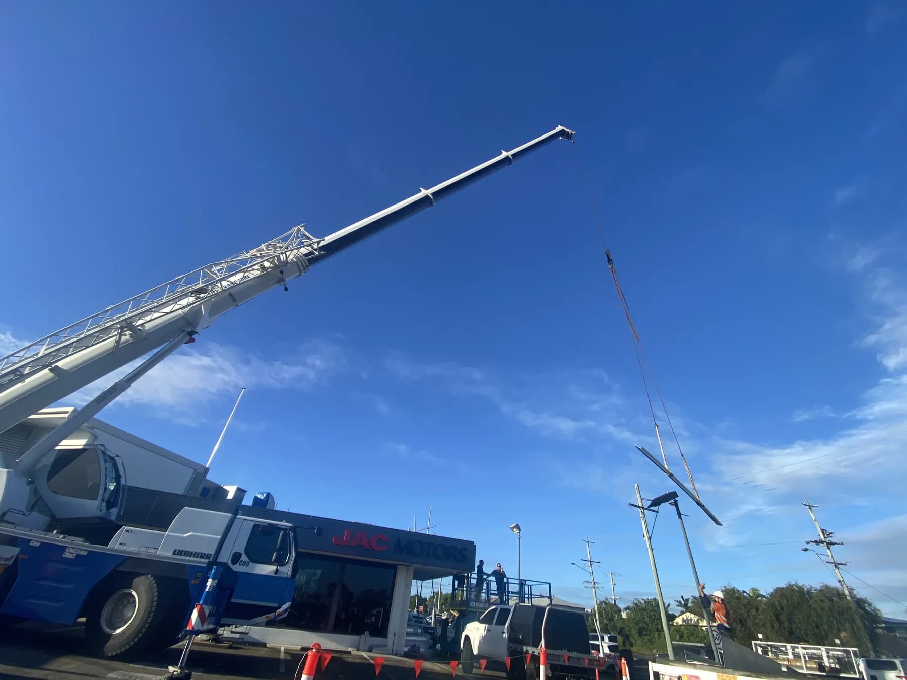 60T crane lifting roofing materials onto the Kippa-Ring car showroom roof