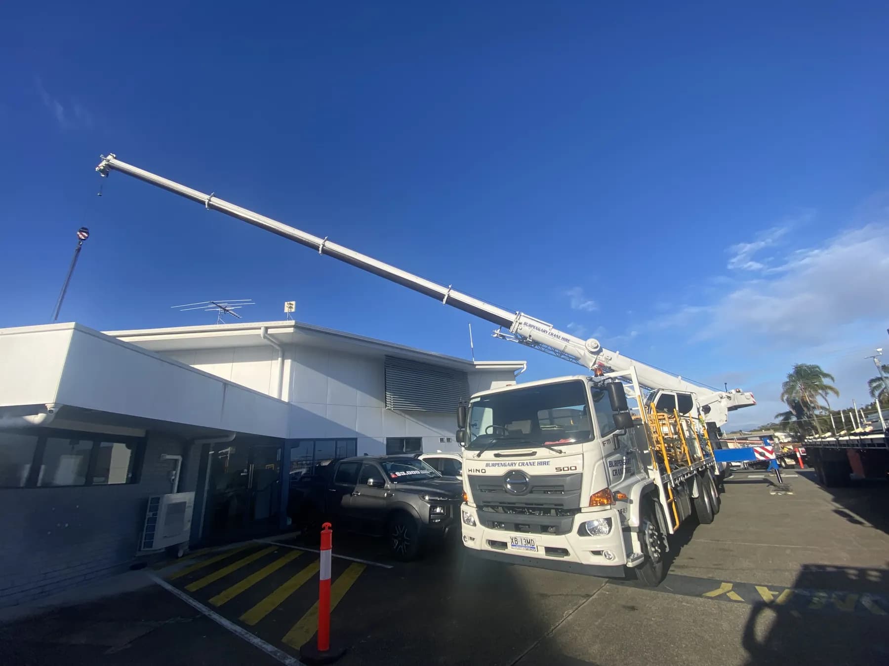 60T crane lifting roofing materials onto the Kippa-Ring car showroom roof