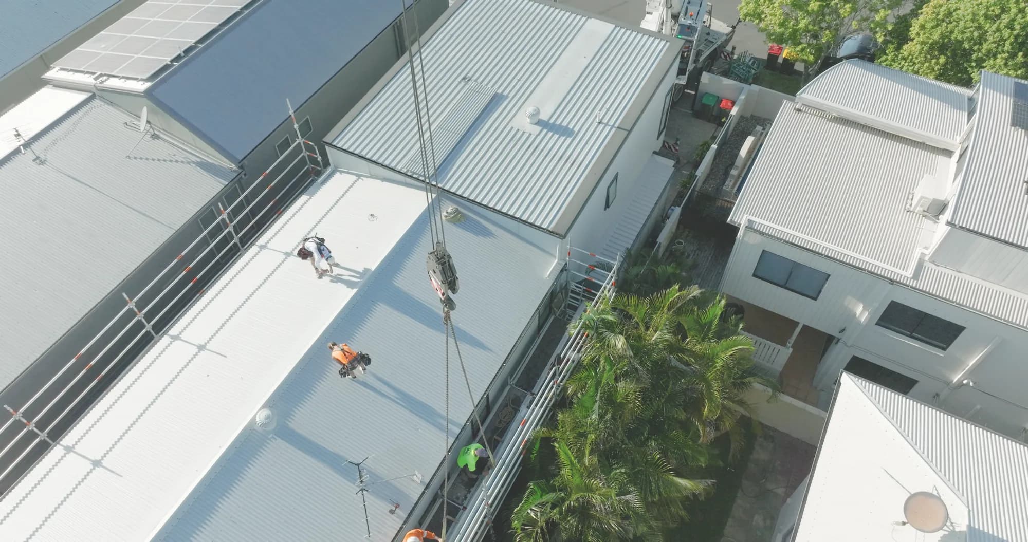 Aerial view of the Manly roof replacement with the crane on site