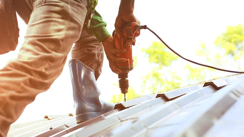 A certified Manchester Roofing operative at work