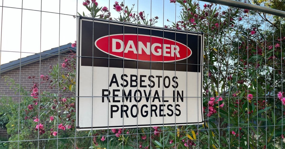 Professional asbestos removal operatives in protective gear