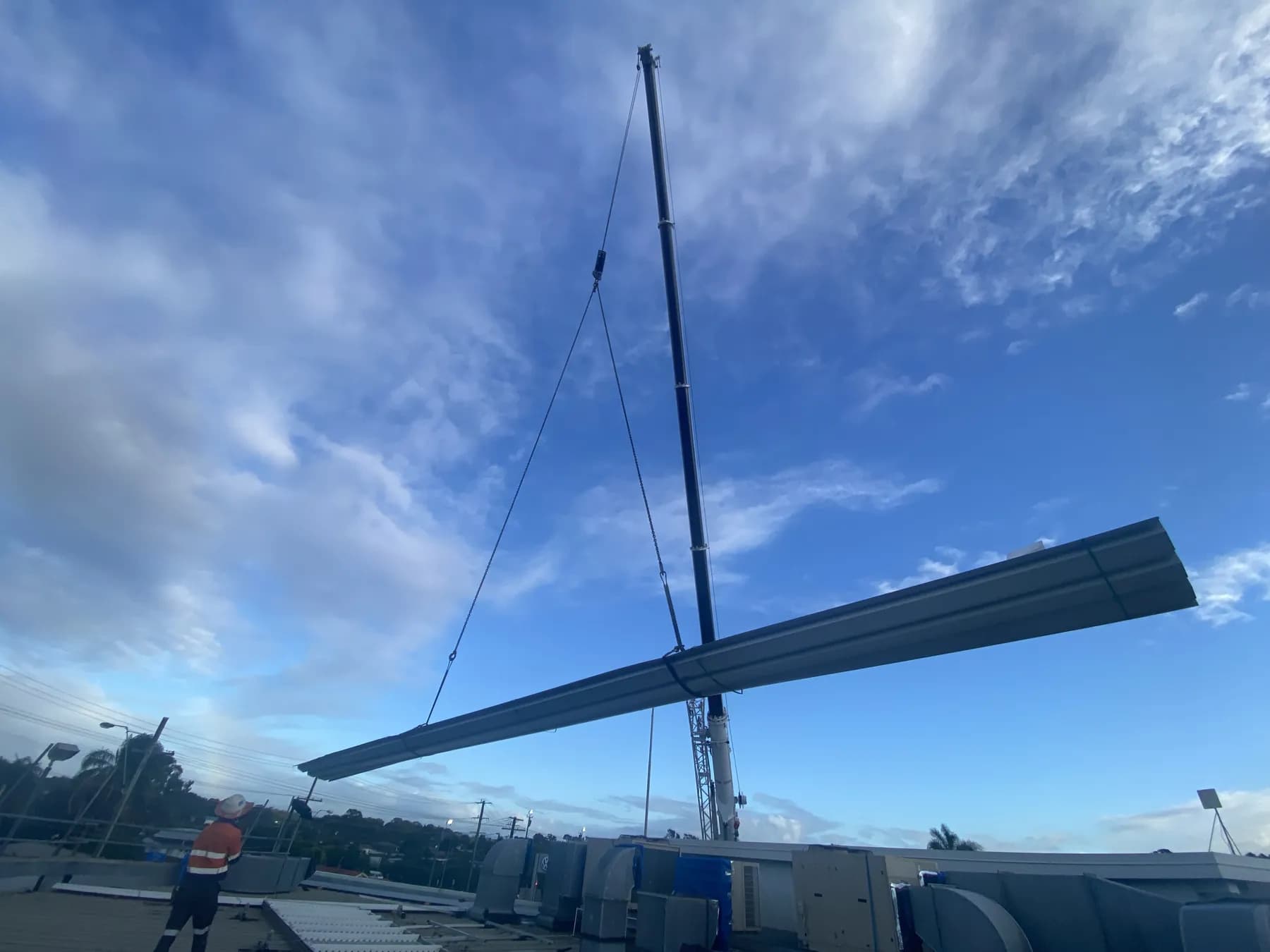60T crane lifting a bundle of roof sheets onto the Kippa-Ring car showroom